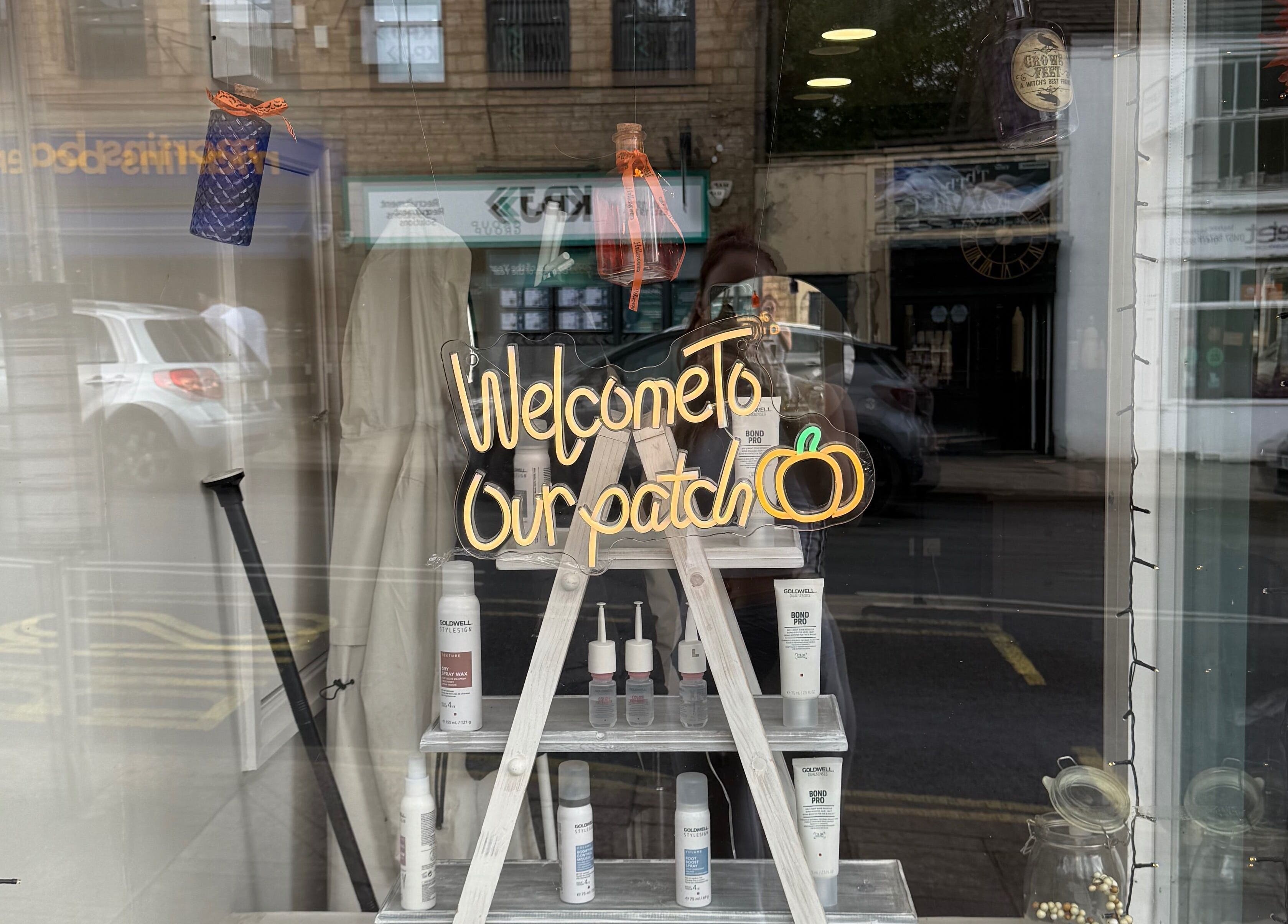 Chic window display at Kendrick and Whyatt Hair Studio, Glossop, England, GB, featuring a 'Welcome' sign.