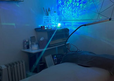 Tranquil treatment room at All About You, St Austell, England, GB with calming blue light ambiance.