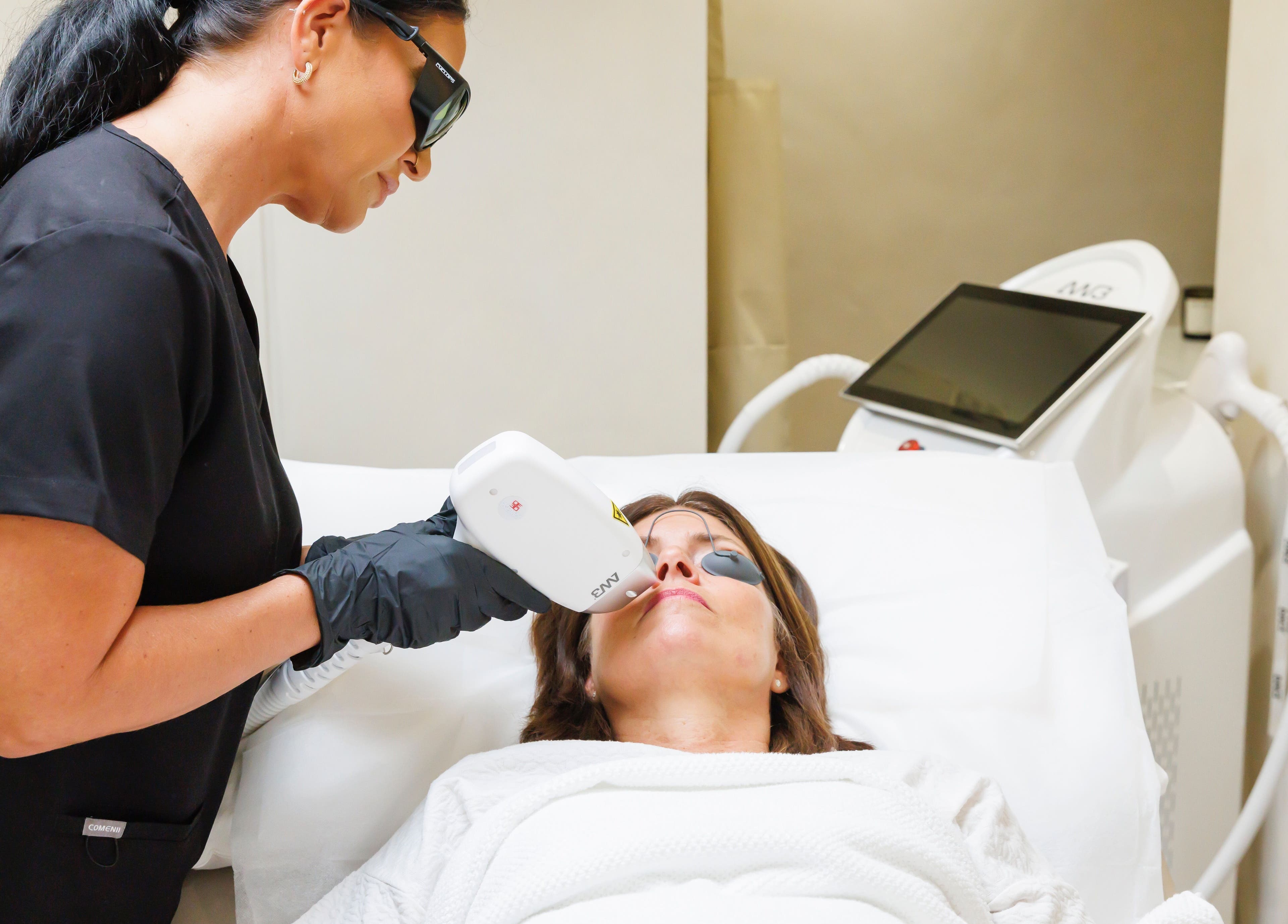 Aesthetician performs laser treatment at Raya Clinic - Skin, PMU & Aesthetics, Havant, England, GB.