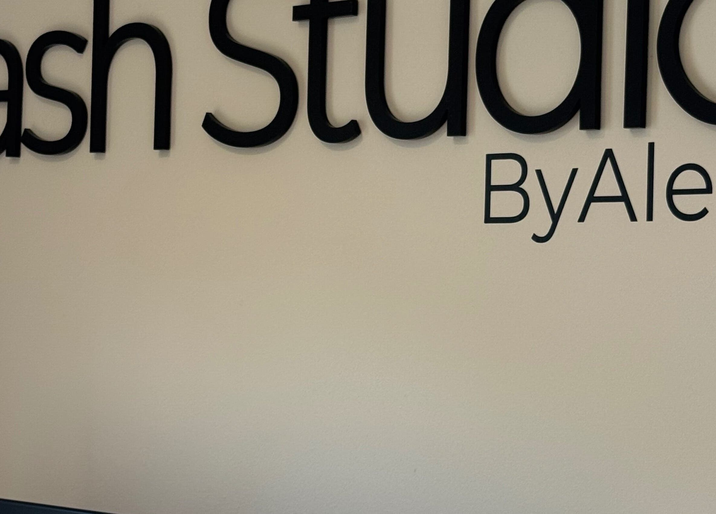 Elegant signage of Lash & Brow Studio, ByAlex in Loughton, England, GB, showcasing its modern font.
