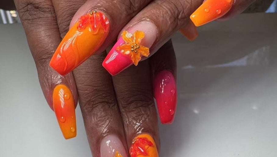Bright floral nail art at Oasis Nail Spa Windermere in Orlando, Florida, US, showcasing orange and pink hues.