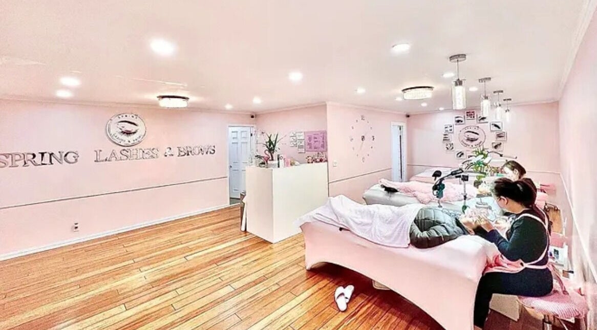 Interior of Spring Lashes and Brows in San Jose, California, US showing treatment area, pink decor, and staff.