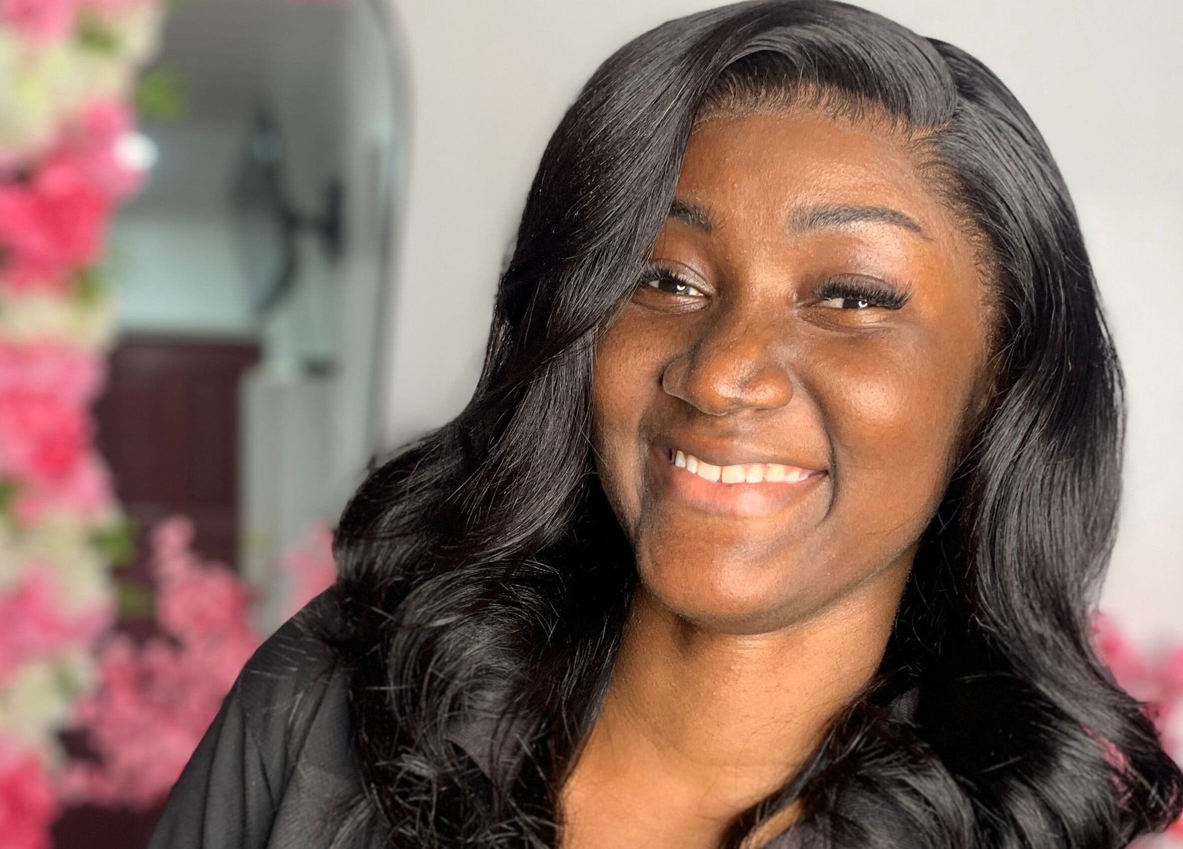 Happy woman with styled hair at Nella Luxe Zone, Georgetown, Demerara-Mahaica, GY.