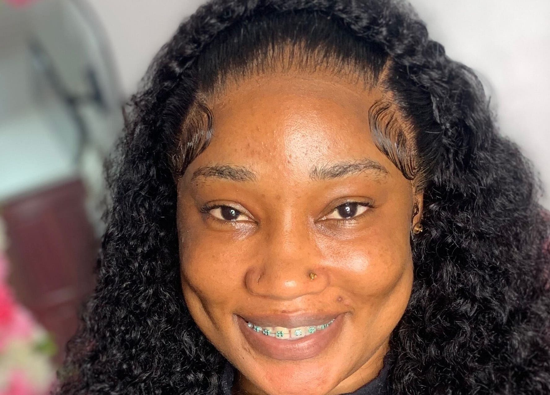 Smiling client with styled hair at Nella Luxe Zone, Georgetown, Demerara-mahaica, GY.