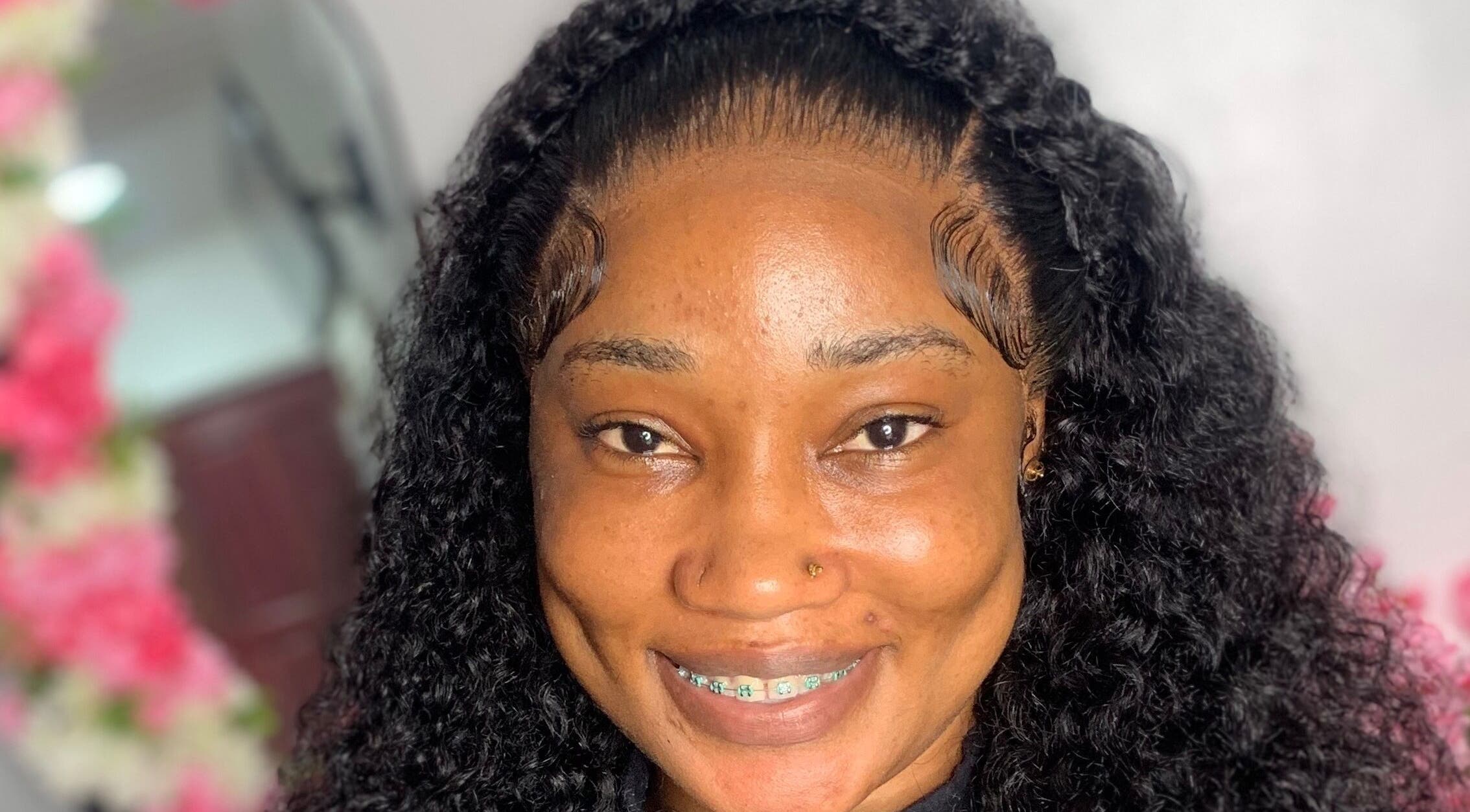 Smiling client with styled hair at Nella Luxe Zone, Georgetown, Demerara-mahaica, GY.