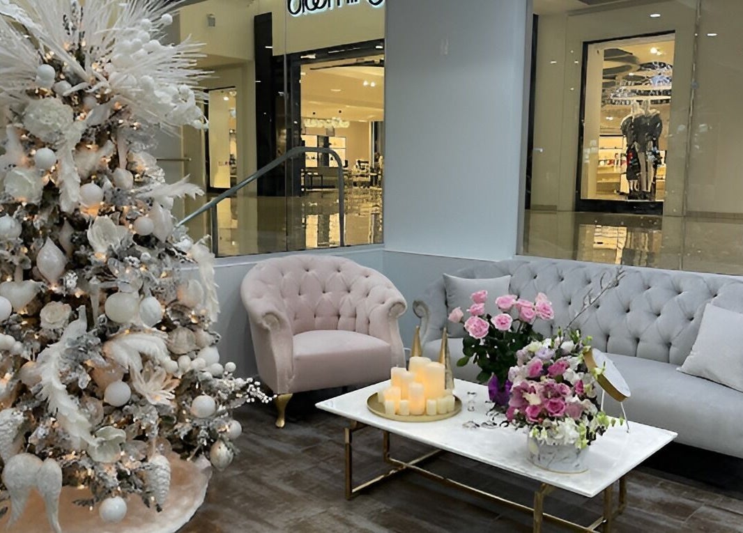 Elegant holiday decor at Luxury Nail and Brow Bar, Glendale, California, US with plush seating and floral accents.