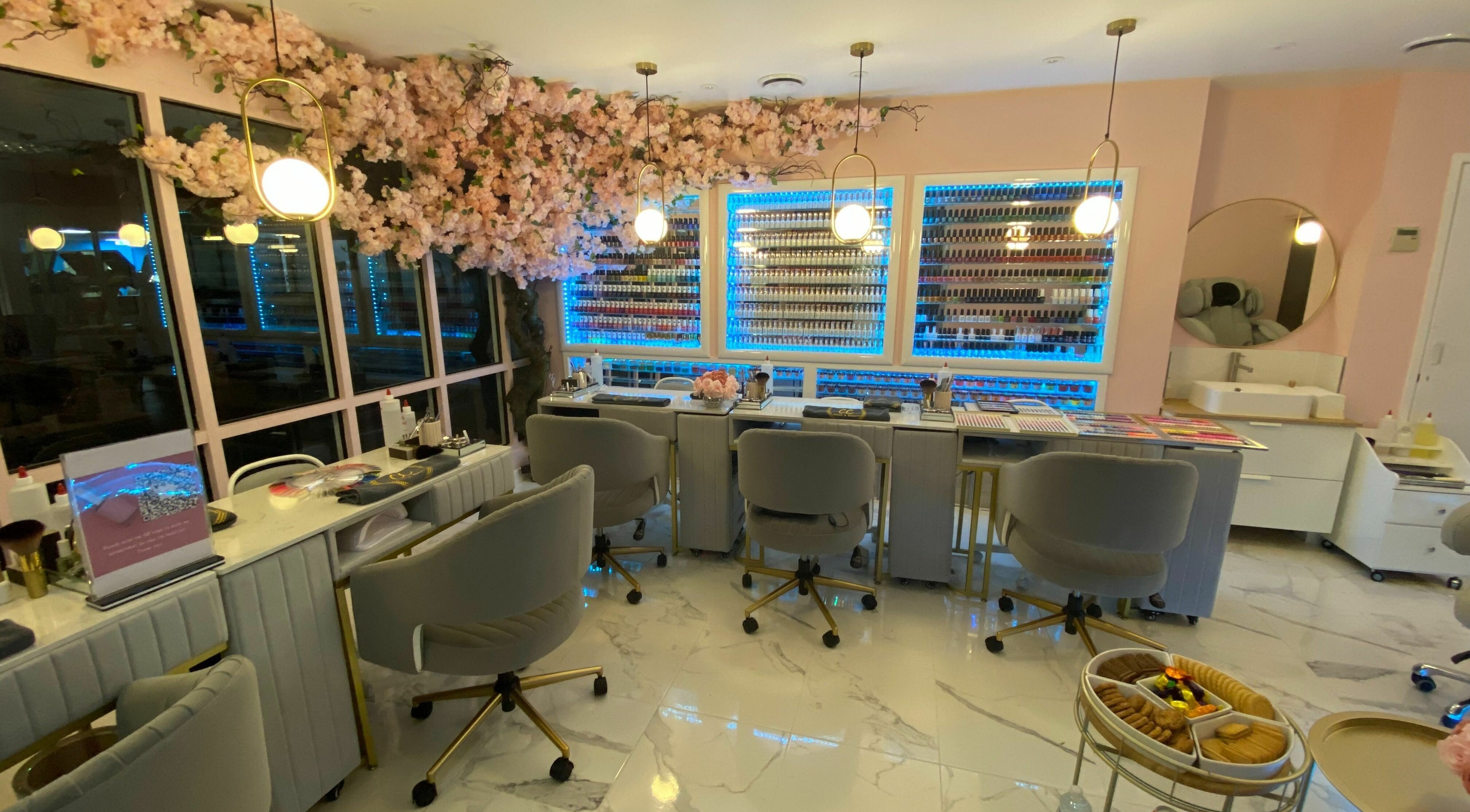 Beautiful interior of CC Nails & Beauty Whitefield with elegant chairs and nail polish displays in Whitefield, England, GB.