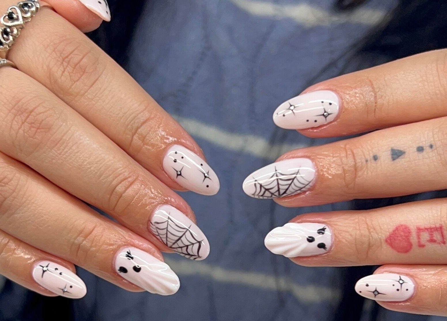 Unique nail art at Dazzling Beauty Lounge, Montgomery, Illinois, US, featuring intricate halloween designs.