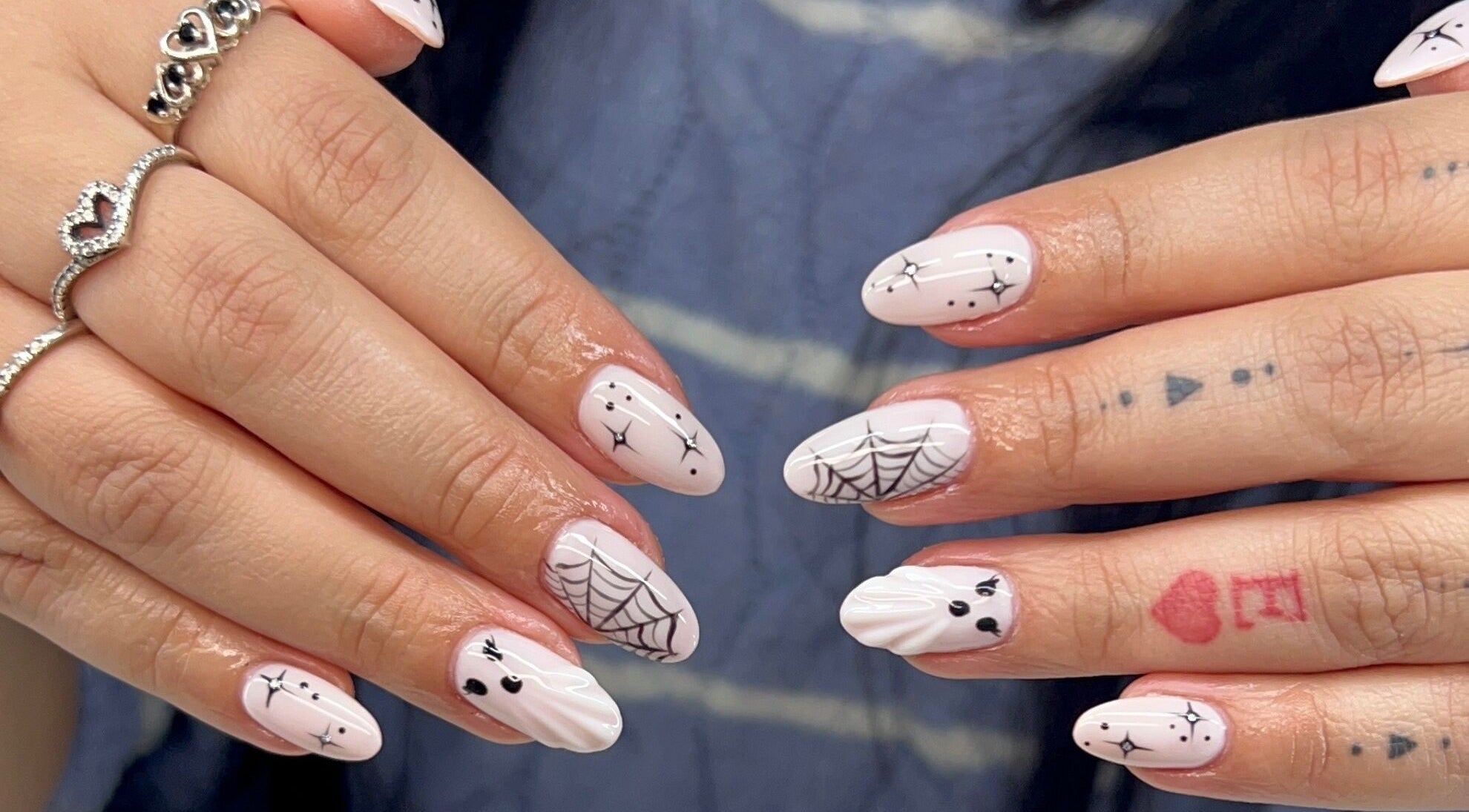 Unique nail art at Dazzling Beauty Lounge, Montgomery, Illinois, US, featuring intricate halloween designs.