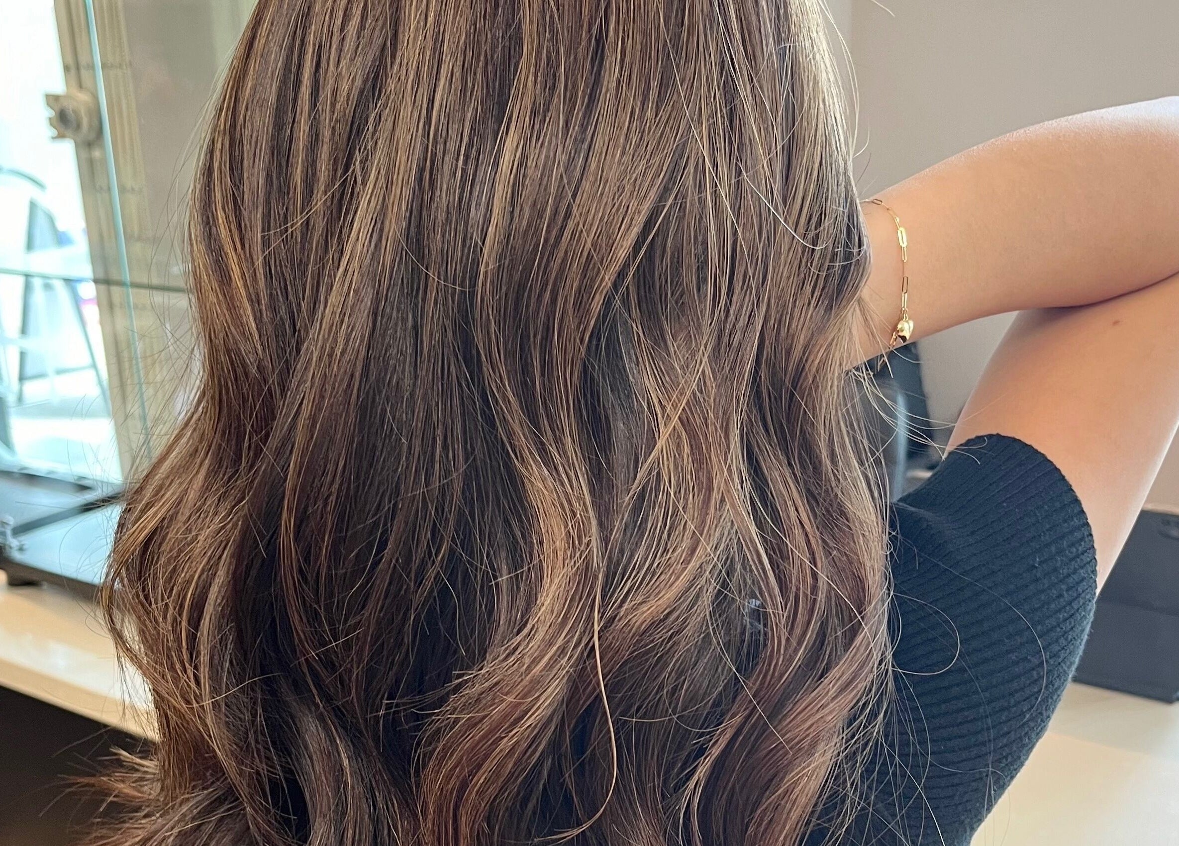 Elegant wavy hair at From Hair On, Port Moody, British Columbia, CA, showcasing stylish brunette highlights.