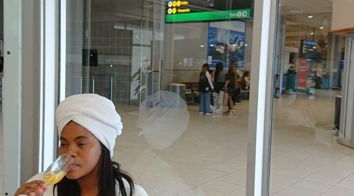 A woman enjoying a drink at Herspace Wellness PE Airport SPA in Gqeberha, Eastern Cape, ZA.