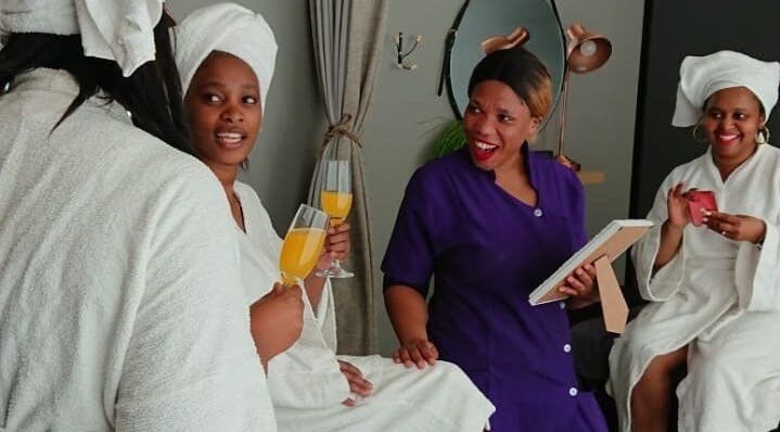 Guests enjoying drinks and conversation at Herspace Wellness PE Airport SPA in Gqeberha, Eastern Cape, ZA.