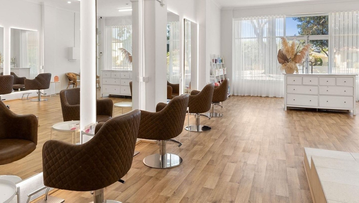 Elegant interior of HD Hair Artistry in Yokine, Western Australia, featuring modern styling chairs and natural light.