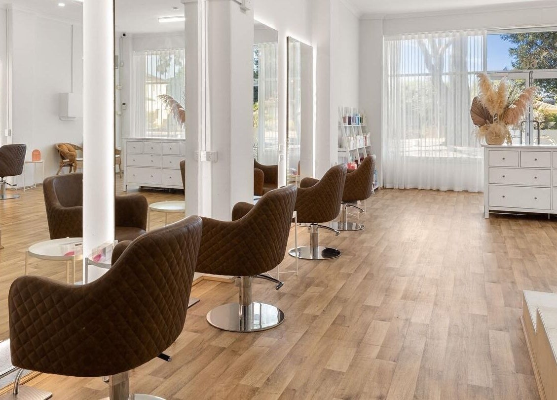 Elegant interior of HD Hair Artistry in Yokine, Western Australia, featuring modern styling chairs and natural light.