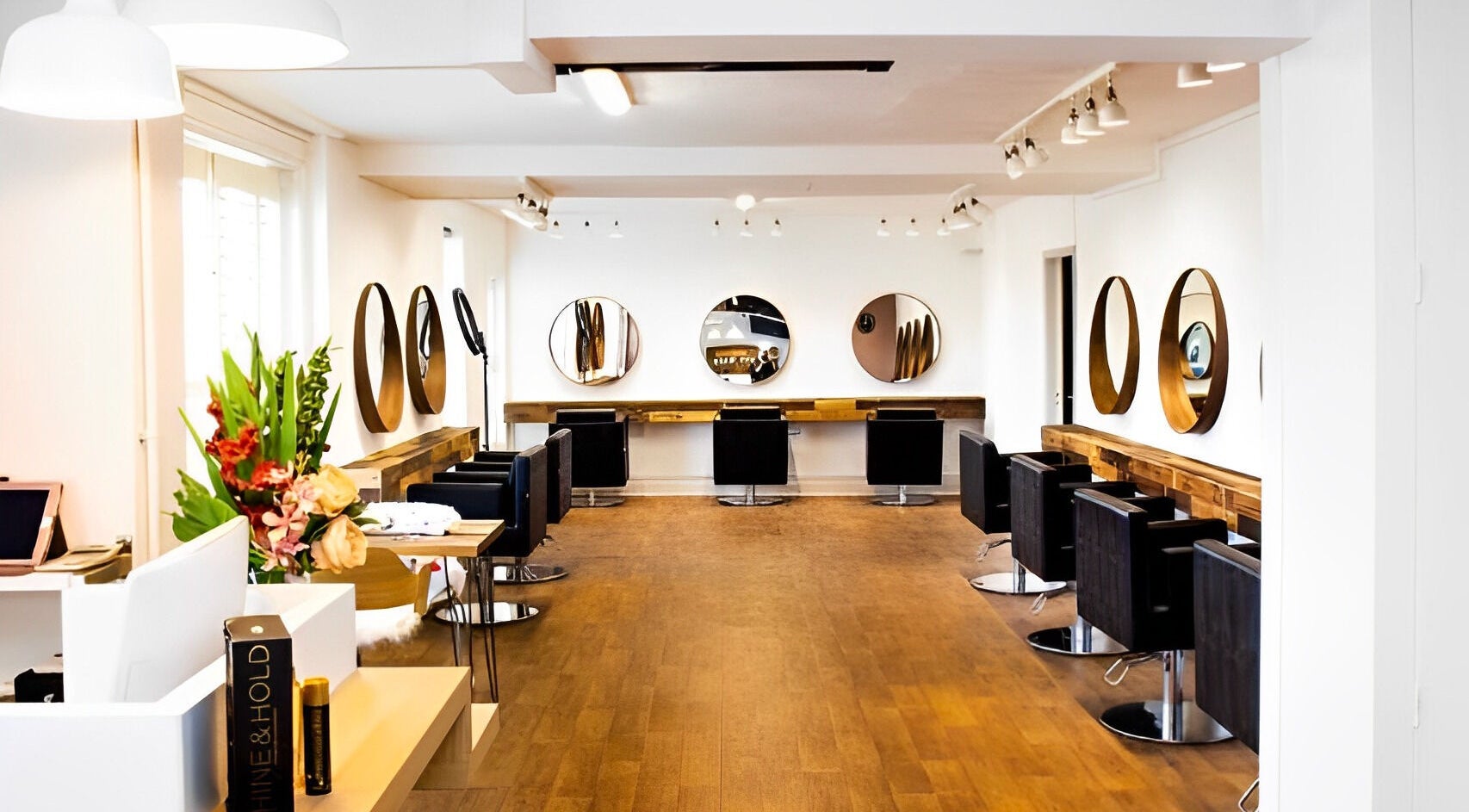 Chic salon interior at Sassy Hair, Derby, England, GB, featuring modern black chairs and mirrors.