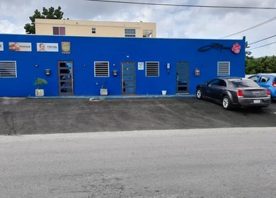 Exterior of Dushi and Beauty, beauty and wellness venue in Willemstad, Curaçao, CW, featuring vibrant blue facade.