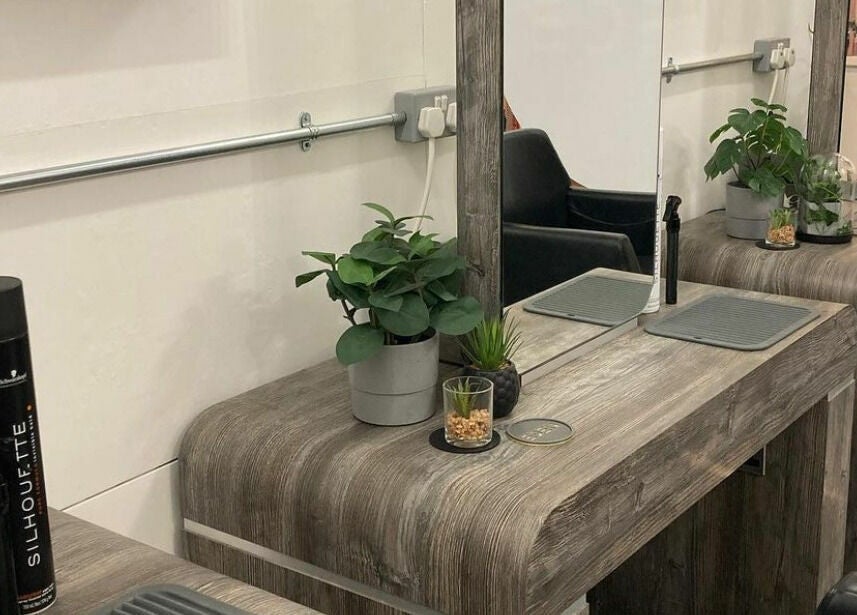 Eden's modern salon station with mirrors and plants in Sheffield, England, GB, offering a stylish experience.