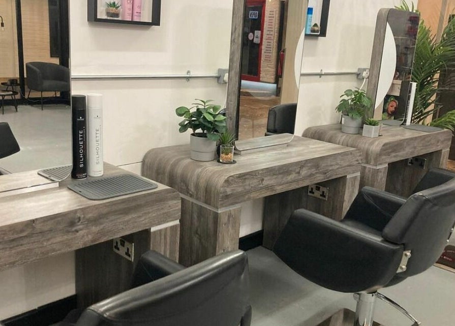 Modern hair salon with stylish chairs at Eden, Sheffield, England, GB, showcasing a sleek, welcoming design.