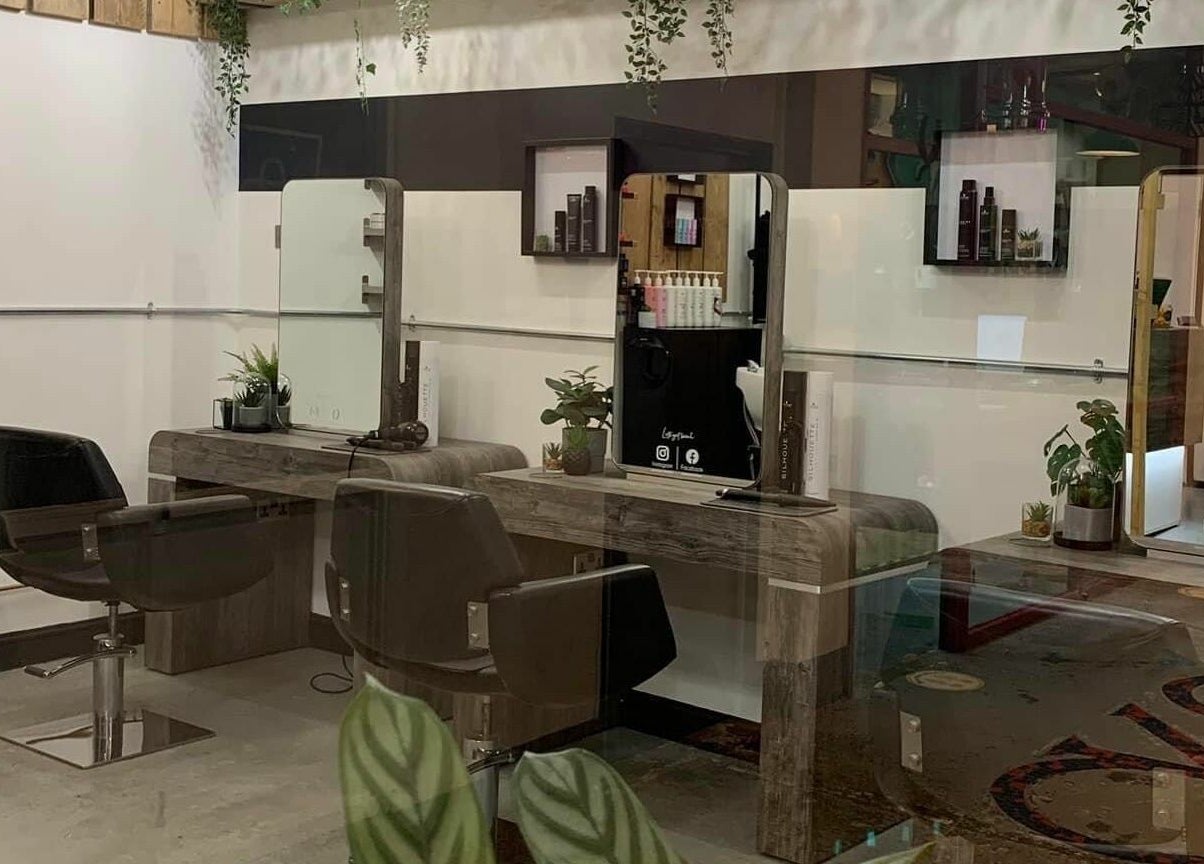 Stylish salon interior at Eden, Sheffield, England, GB showcasing modern chairs and lush decor.