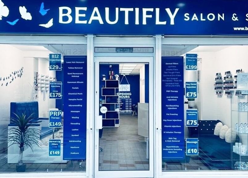 Beautifly salon in Romford, England, GB, showcasing stylish entrance with beauty service details on display.