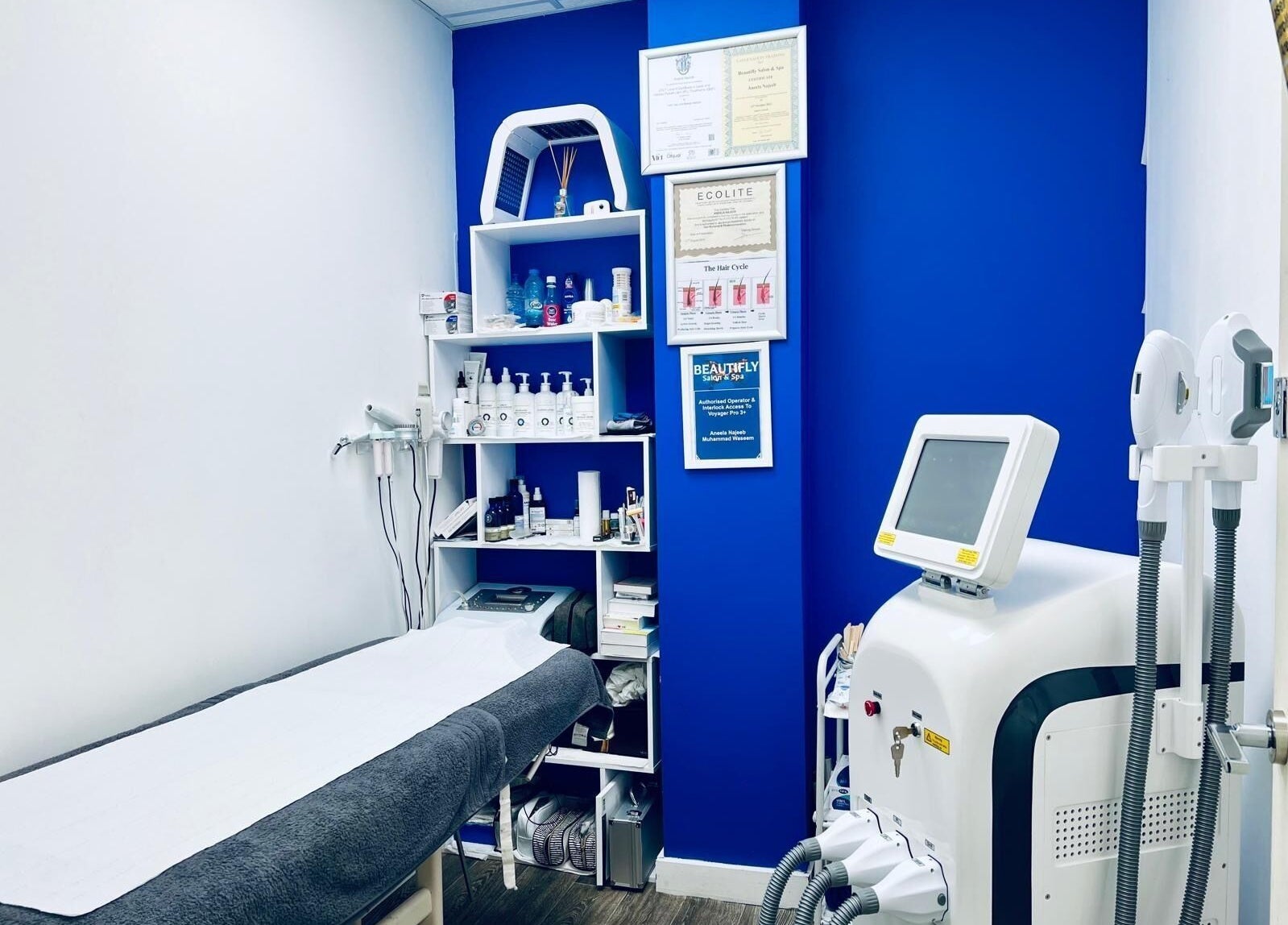 Sleek modern treatment room at Beautifly, Romford, England, GB featuring advanced beauty equipment and products.