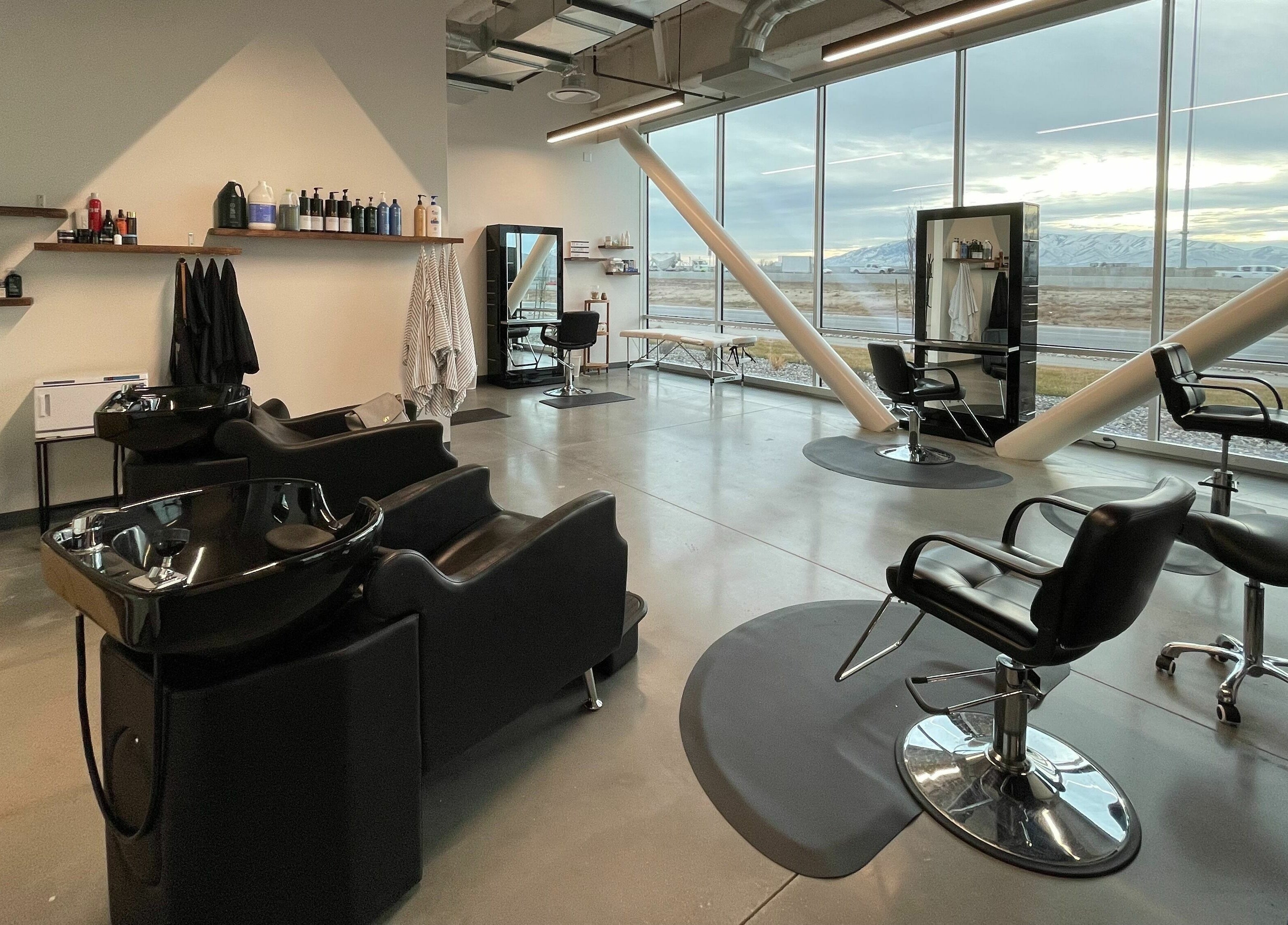 Modern interior of Weave Salon in Lehi, Utah, US showcasing elegant styling and washing stations.