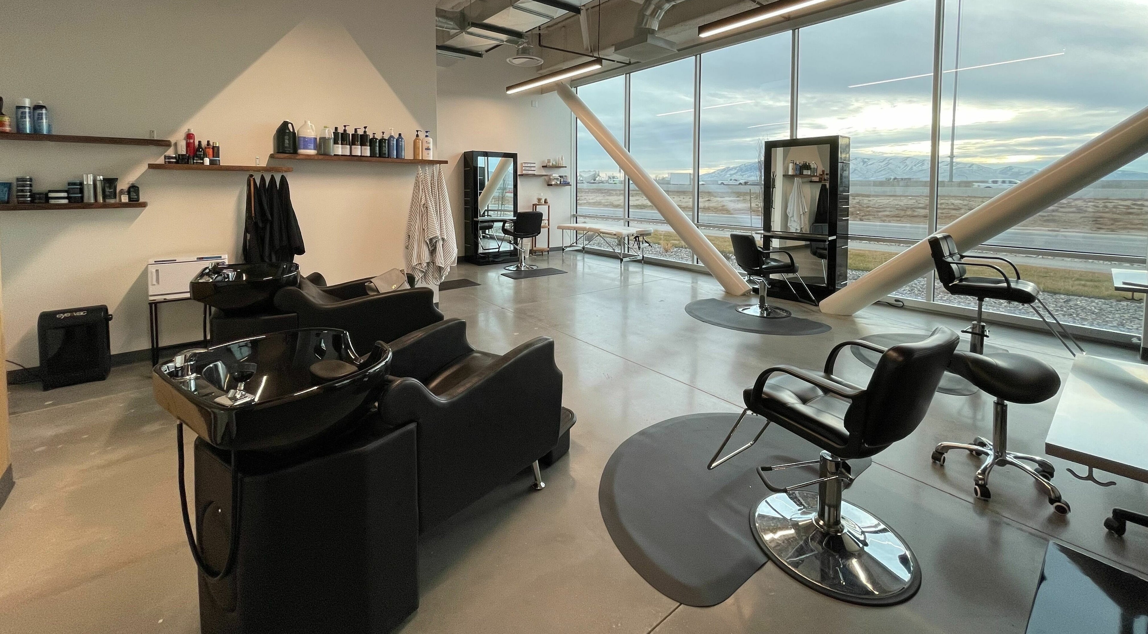 Modern interior of Weave Salon in Lehi, Utah, US showcasing elegant styling and washing stations.