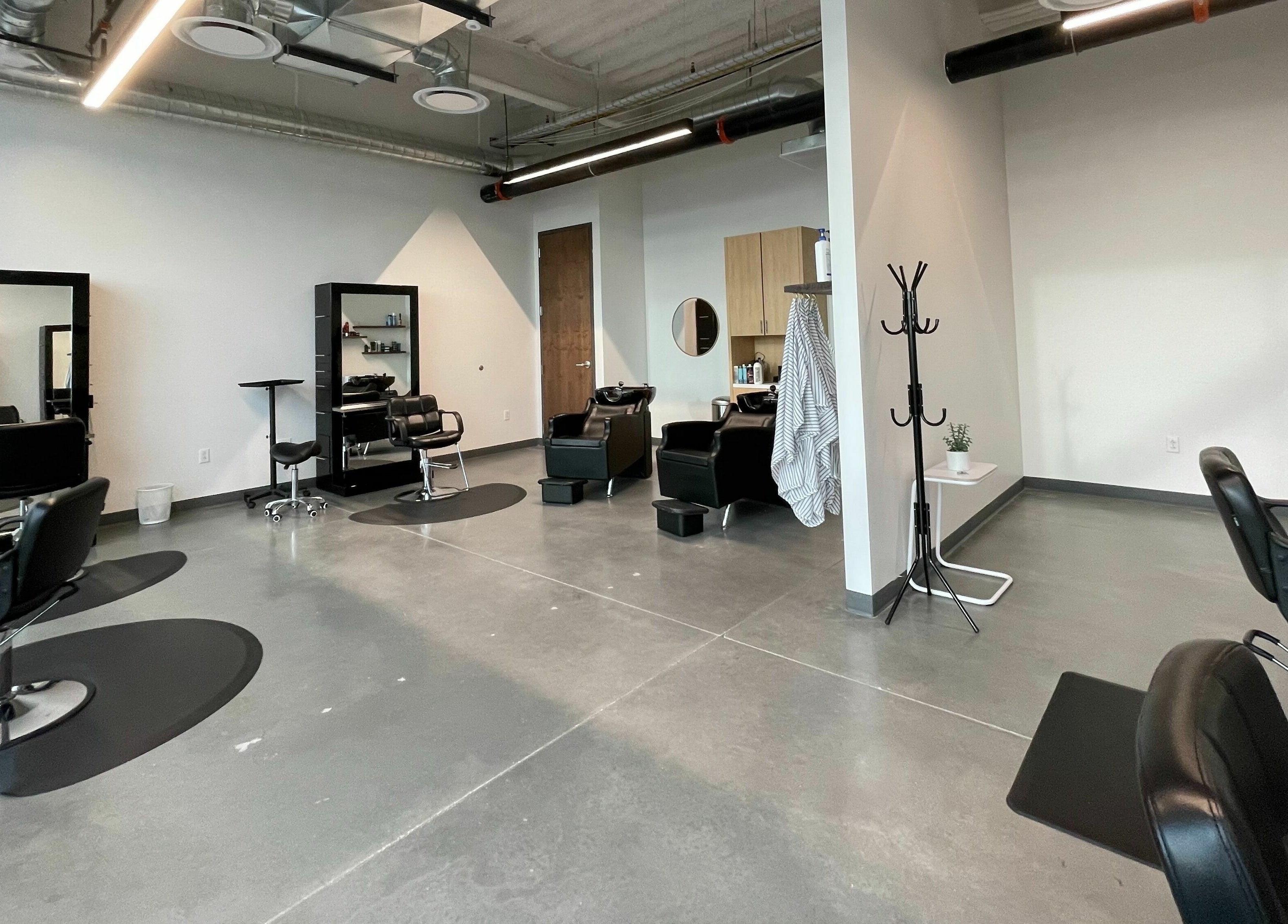 Modern interior of Weave Salon in Lehi, Utah, US, featuring stylish chairs and sleek mirrors.