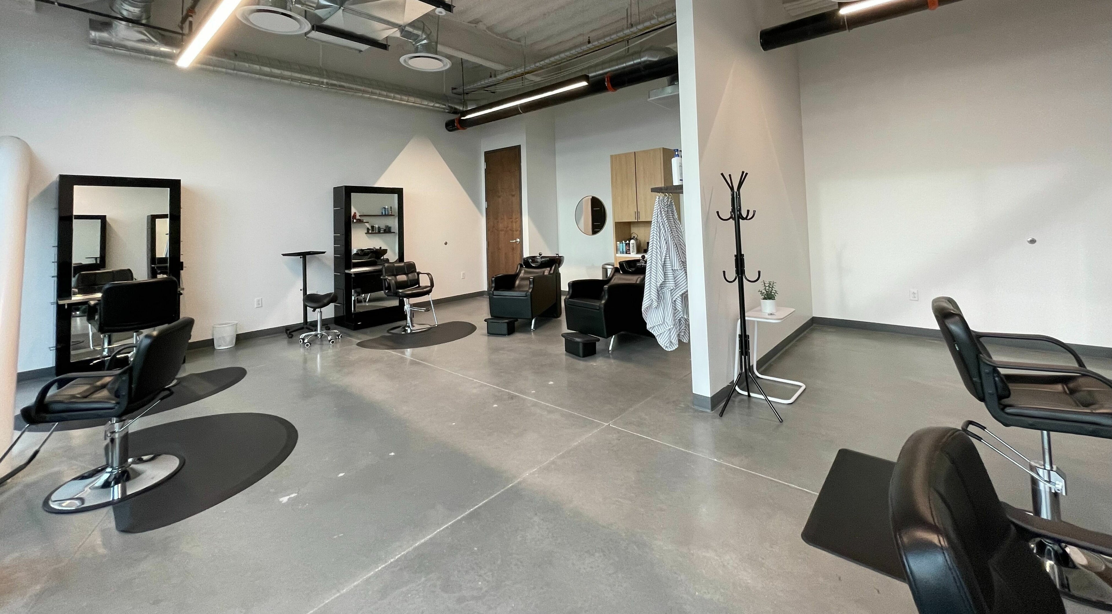 Modern interior of Weave Salon in Lehi, Utah, US, featuring stylish chairs and sleek mirrors.