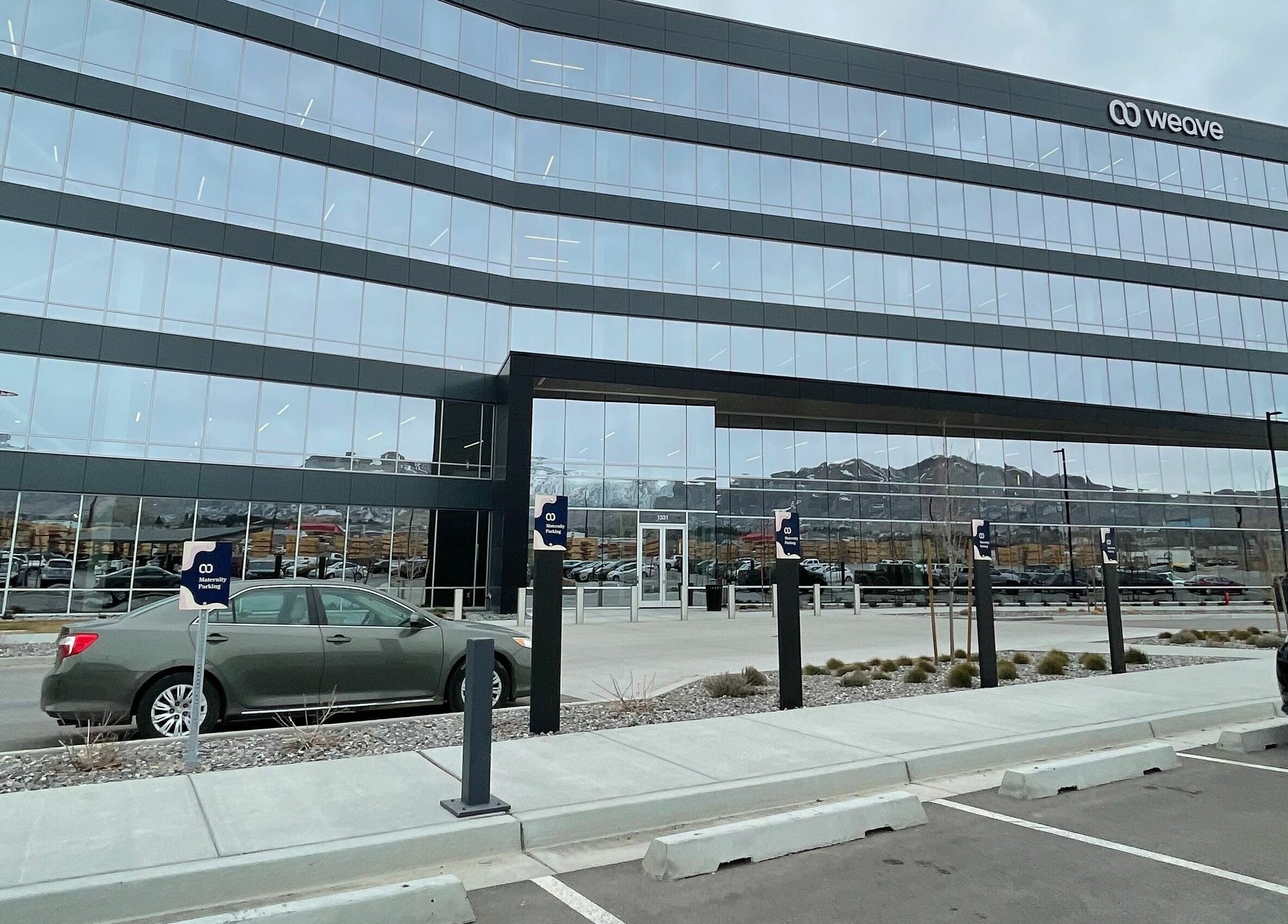 Weave Salon's sleek glass building in Lehi, Utah, US, showcasing modern architecture.
