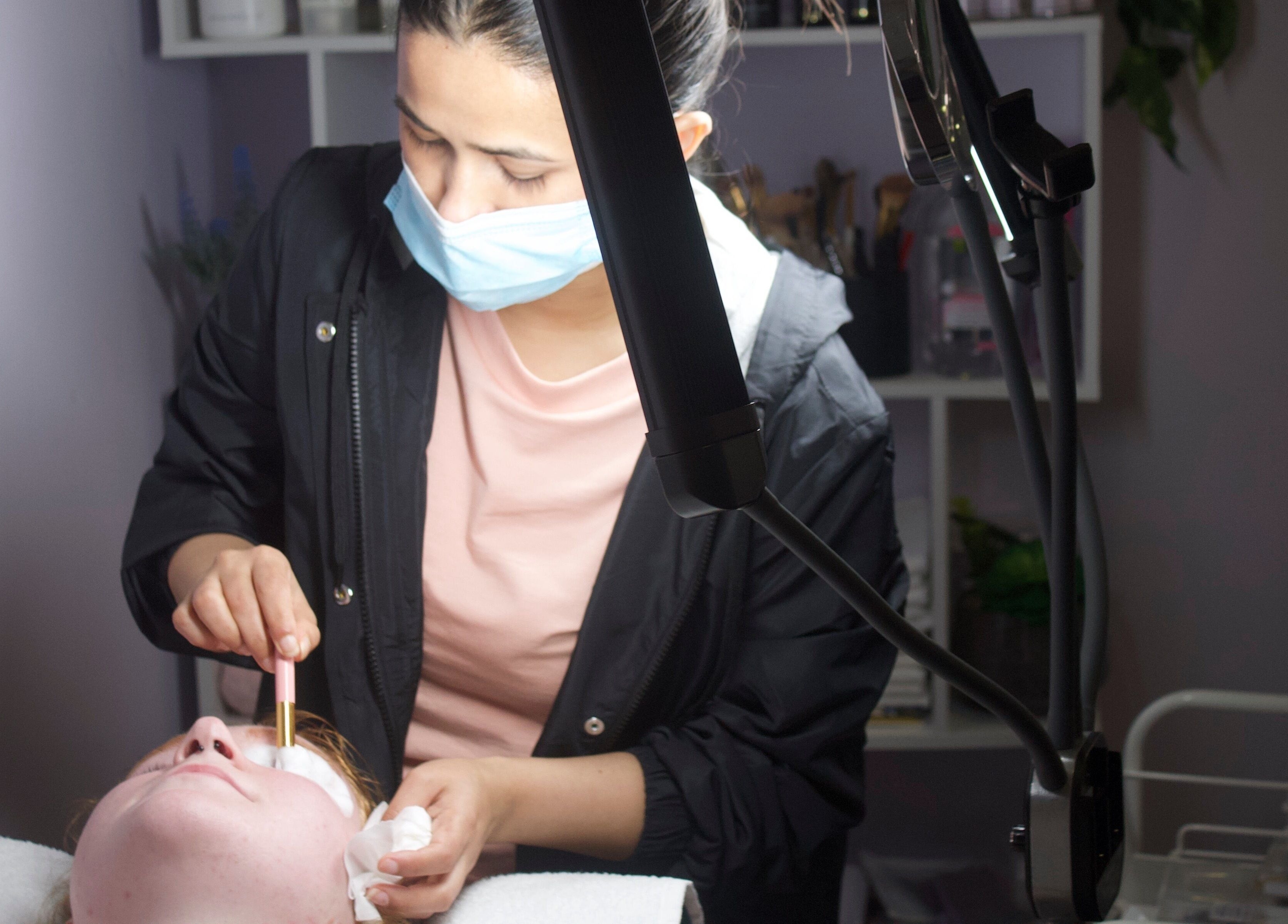 Therapist applying facial at Beauty & Brow By Sus, Brookvale, New South Wales, AU.