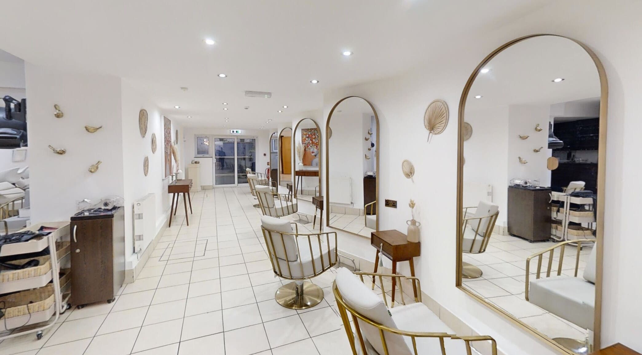 Sleek interior of The Laser Clinic Exmouth Ltd in Exmouth, England, GB showcasing modern chairs and large mirrors.