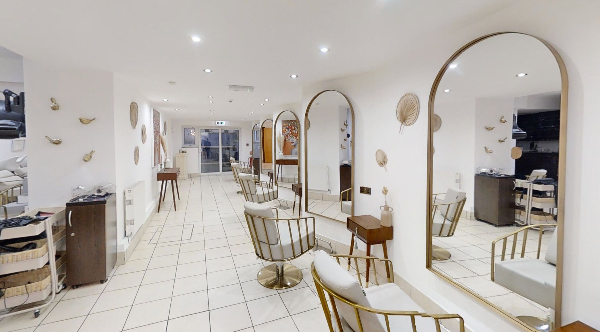 Sleek interior of The Laser Clinic Exmouth Ltd in Exmouth, England, GB showcasing modern chairs and large mirrors.
