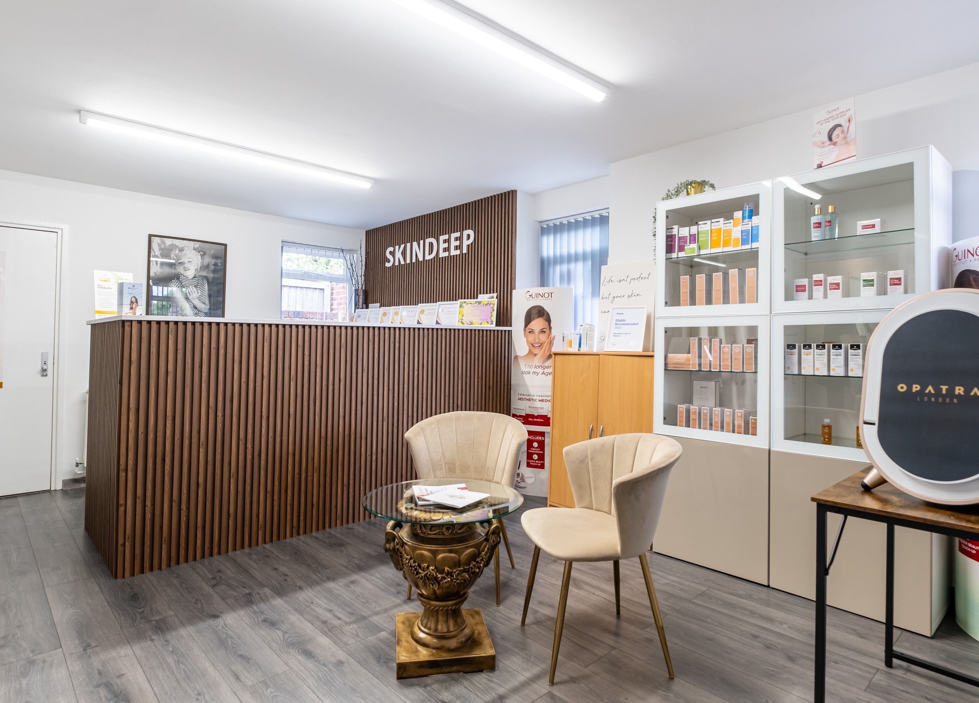 Modern reception area of Skindeep Laser & Beauty in Coventry, England, GB, featuring stylish decor and product displays.