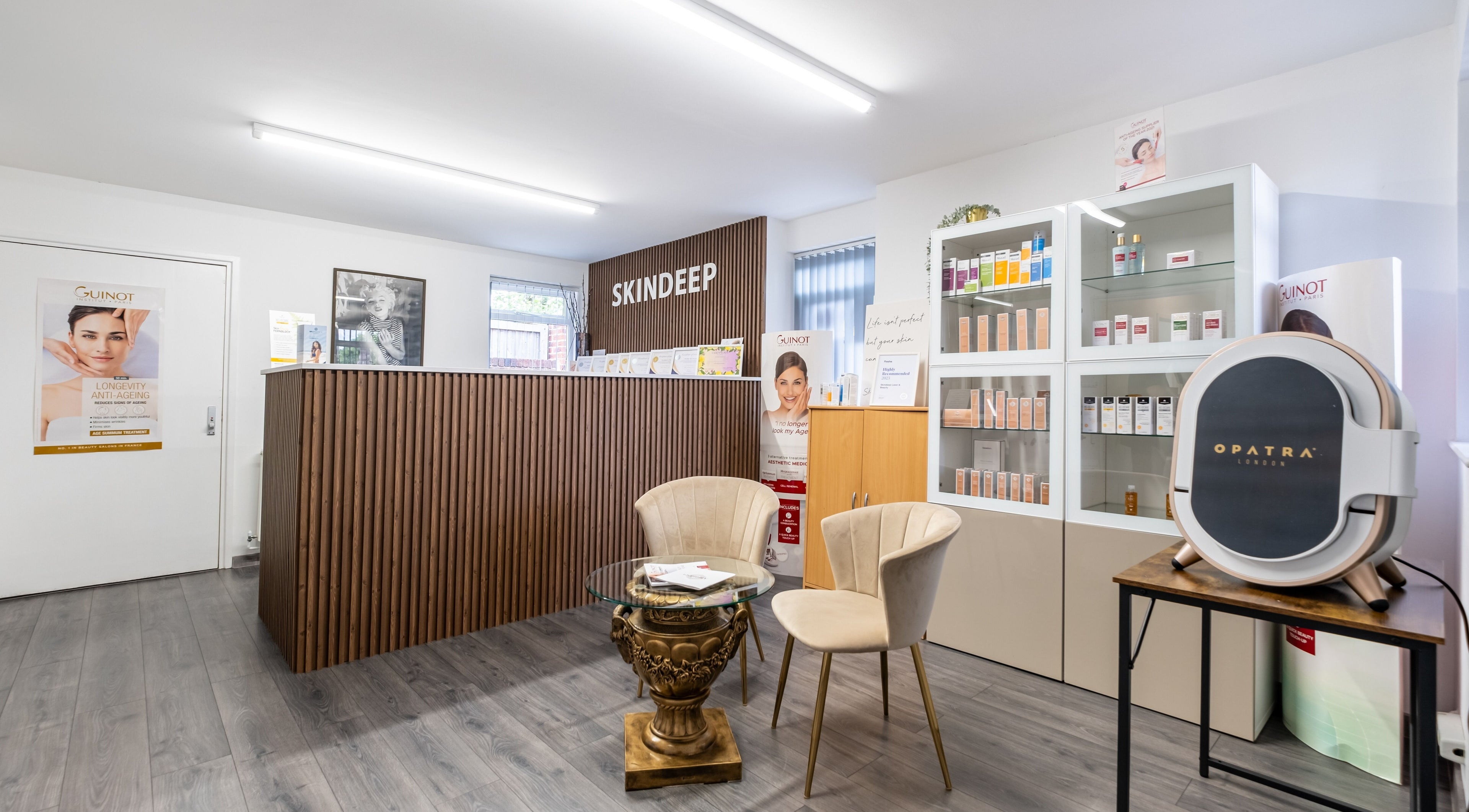Modern reception area of Skindeep Laser & Beauty in Coventry, England, GB, featuring stylish decor and product displays.