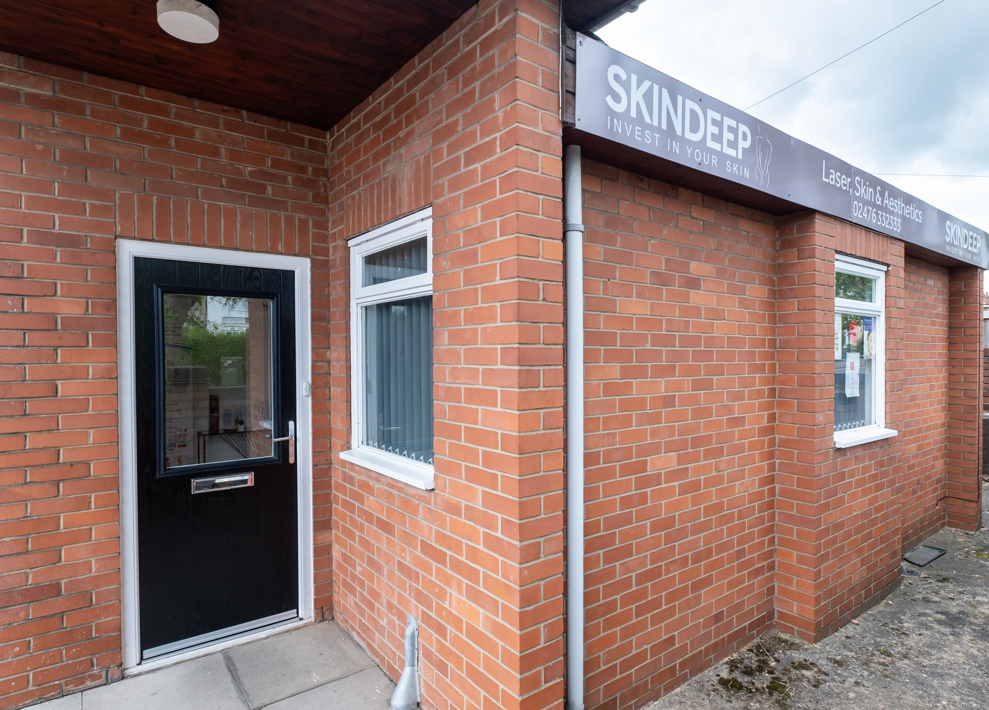 Entrance to Skindeep Laser & Beauty in Coventry, England, GB, with a welcoming brick facade.