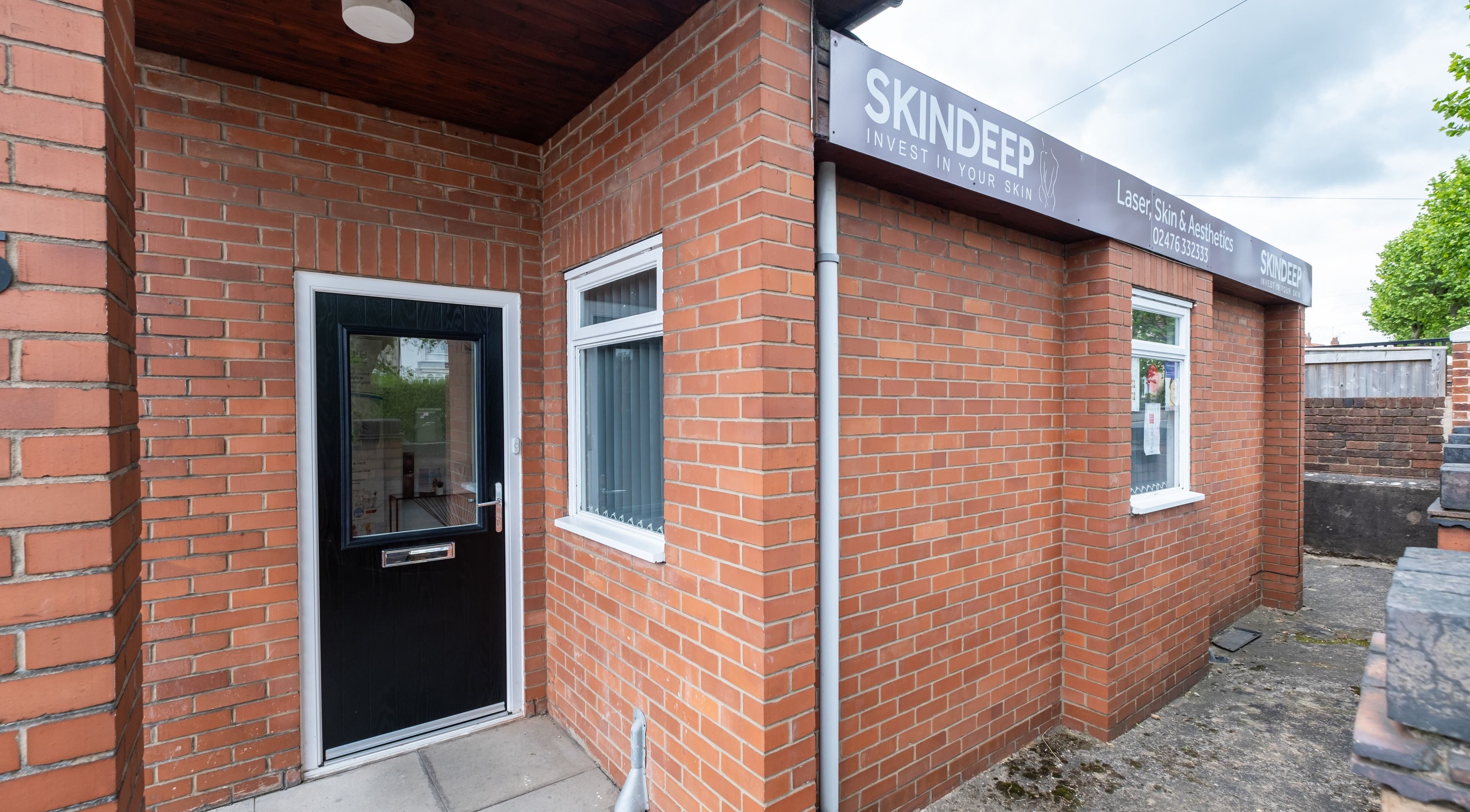 Entrance to Skindeep Laser & Beauty in Coventry, England, GB, with a welcoming brick facade.