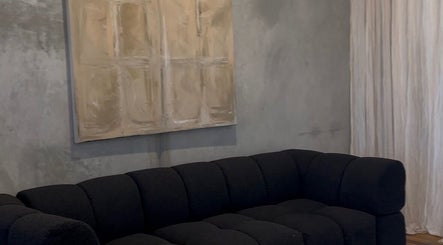 Elegant black sofa and abstract artwork at Pause, Byron Bay, New South Wales, AU.