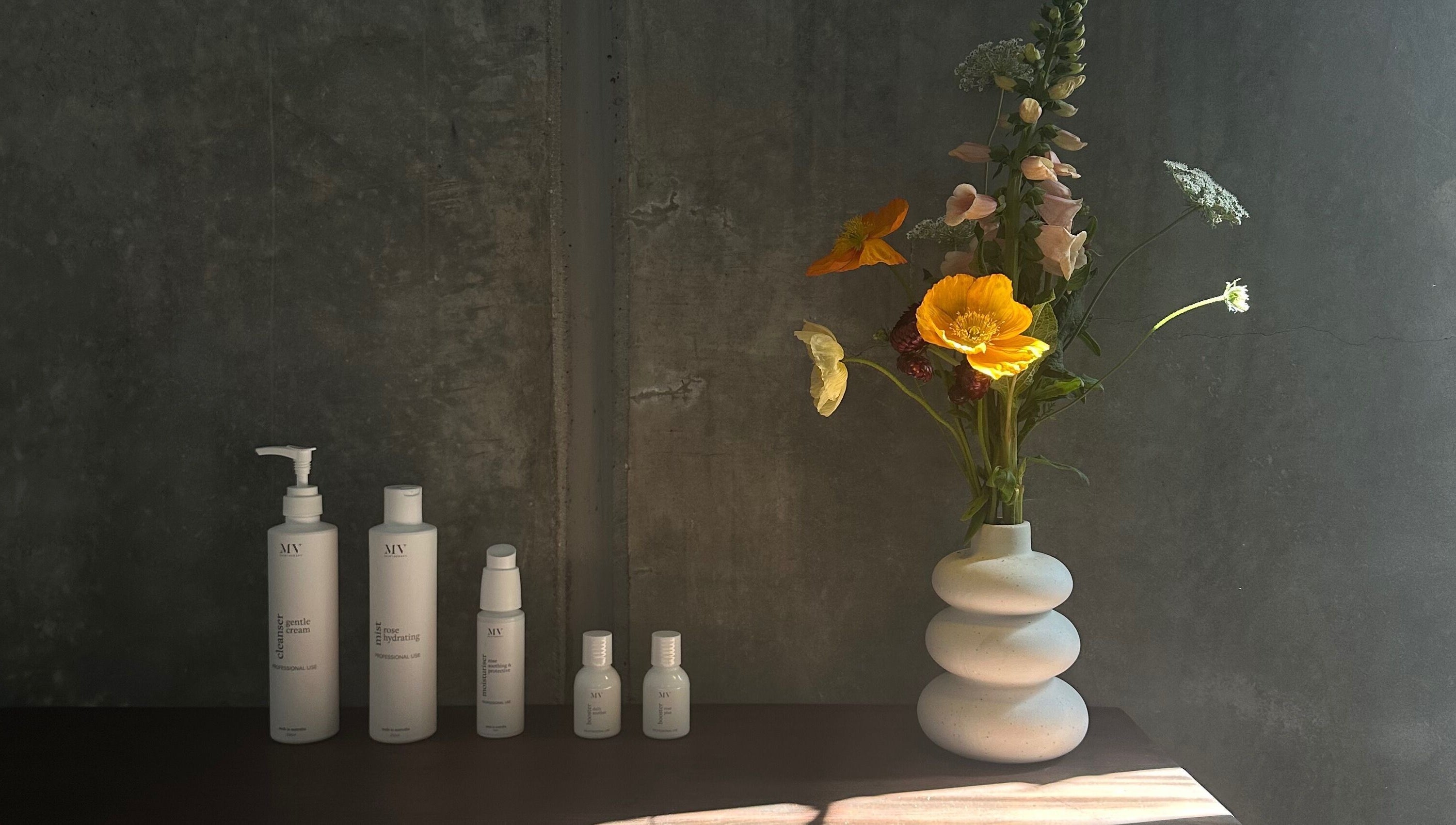 Skincare products and floral vase at Pause, Byron Bay, New South Wales, AU.