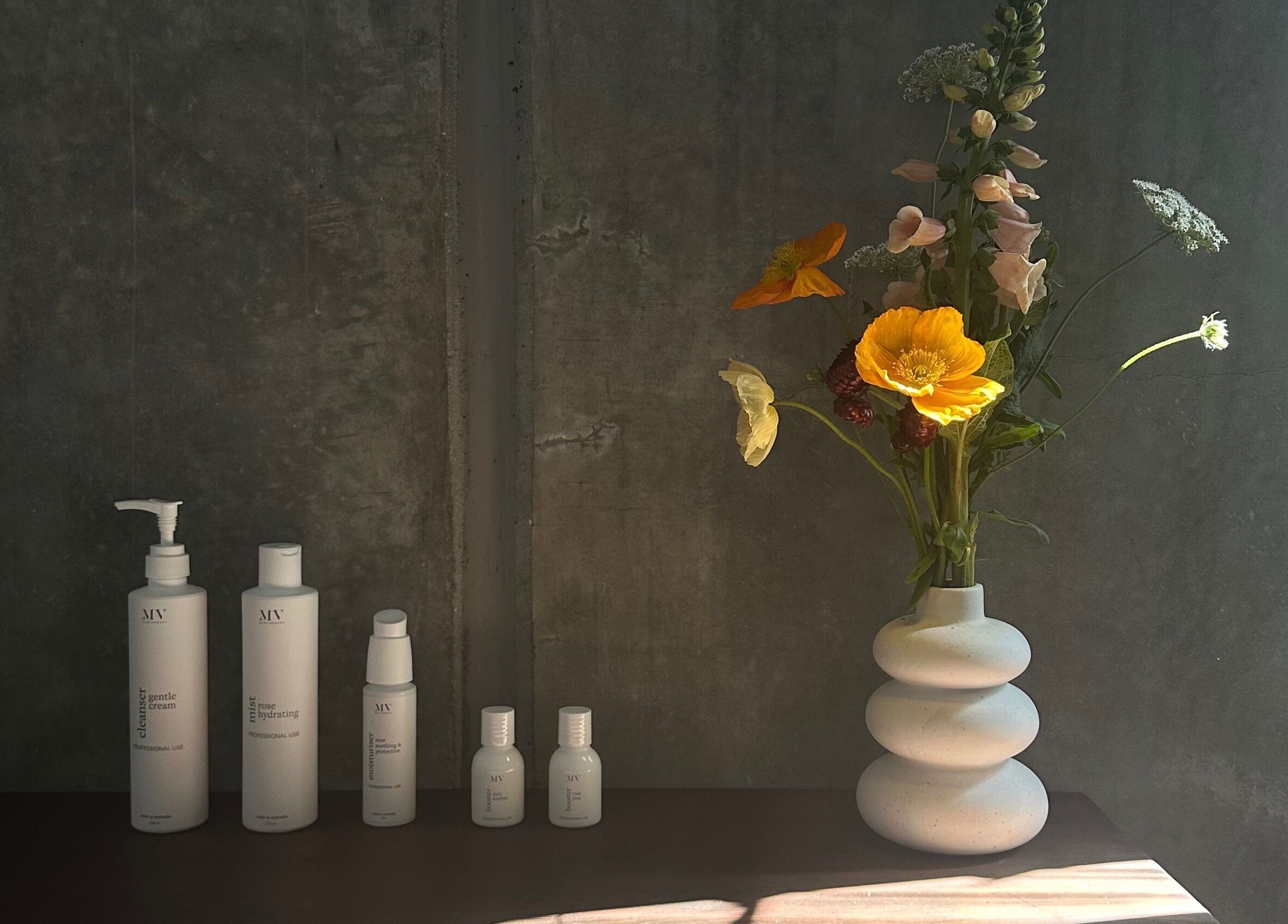 Skincare products and floral vase at Pause, Byron Bay, New South Wales, AU.