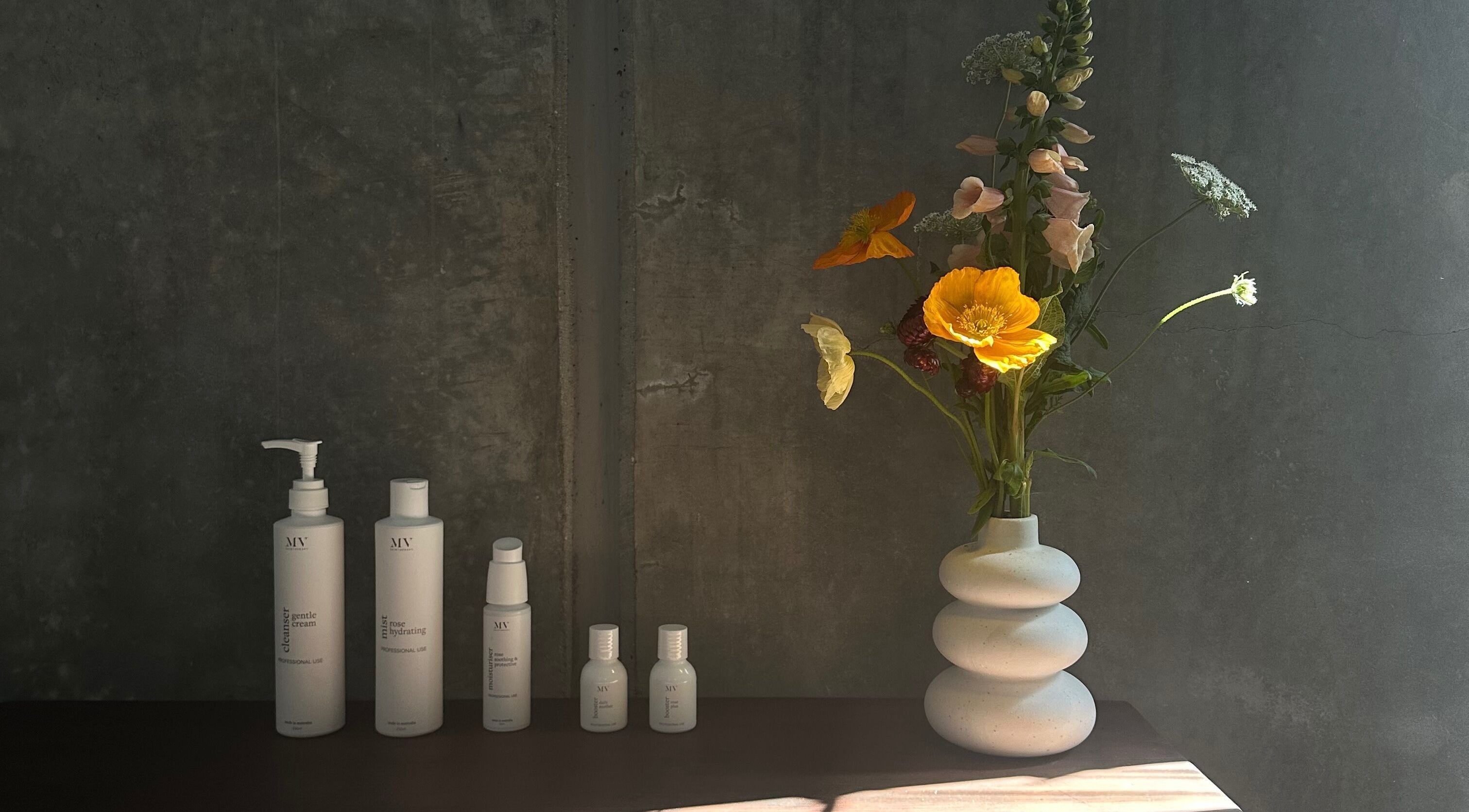 Skincare products and floral vase at Pause, Byron Bay, New South Wales, AU.