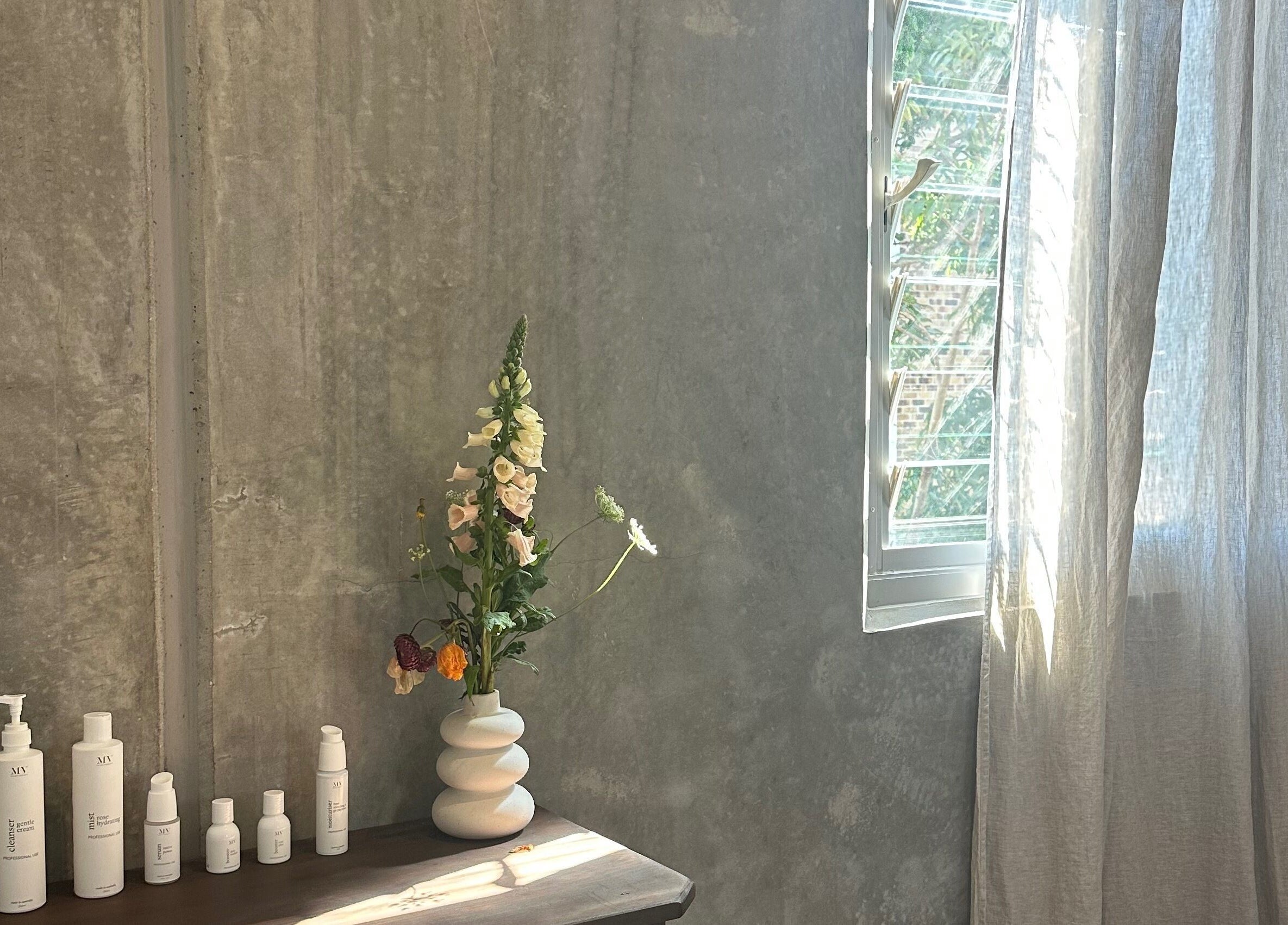 Minimalist beauty corner at Pause, Byron Bay, New South Wales, AU with sunlight and products.