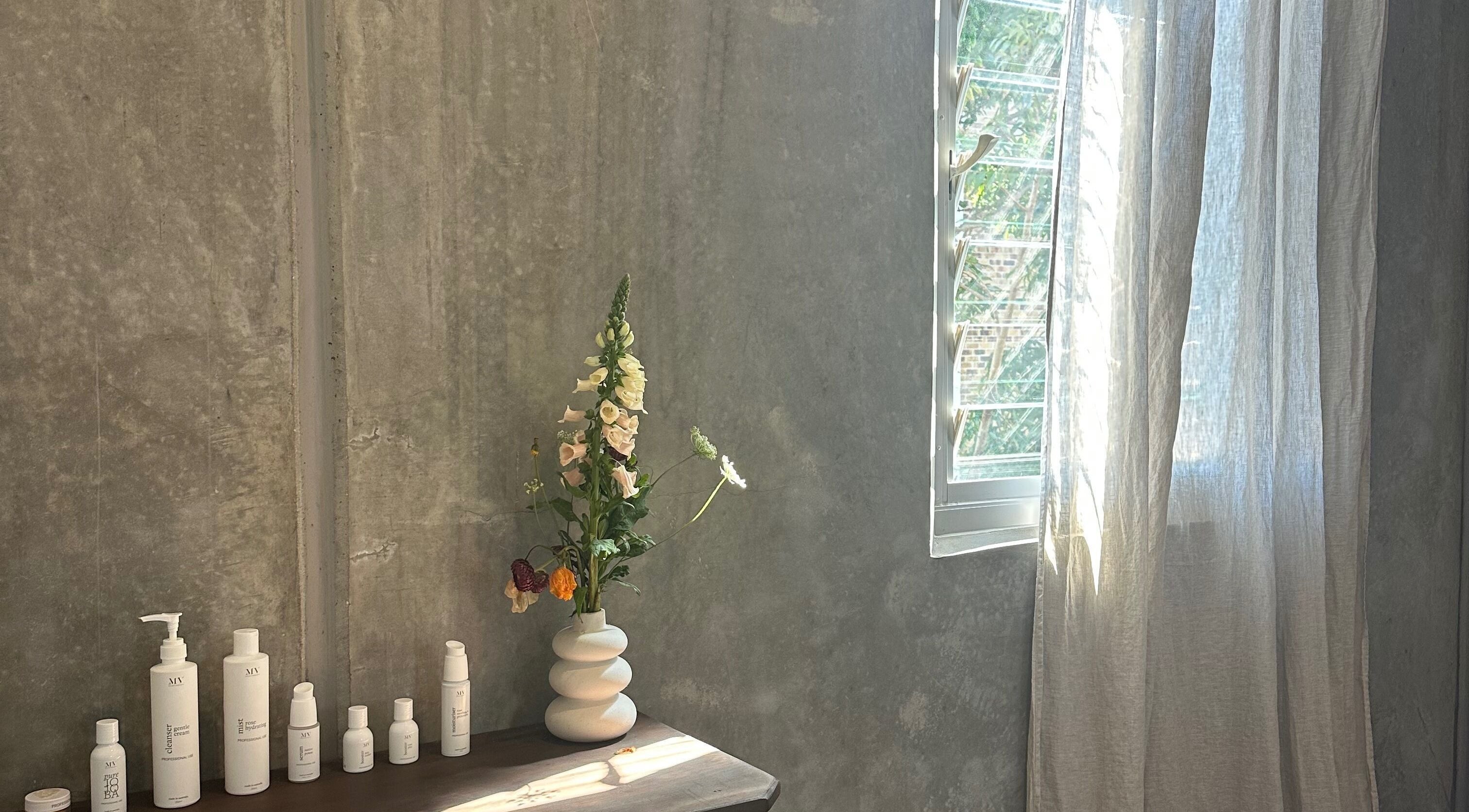 Minimalist beauty corner at Pause, Byron Bay, New South Wales, AU with sunlight and products.