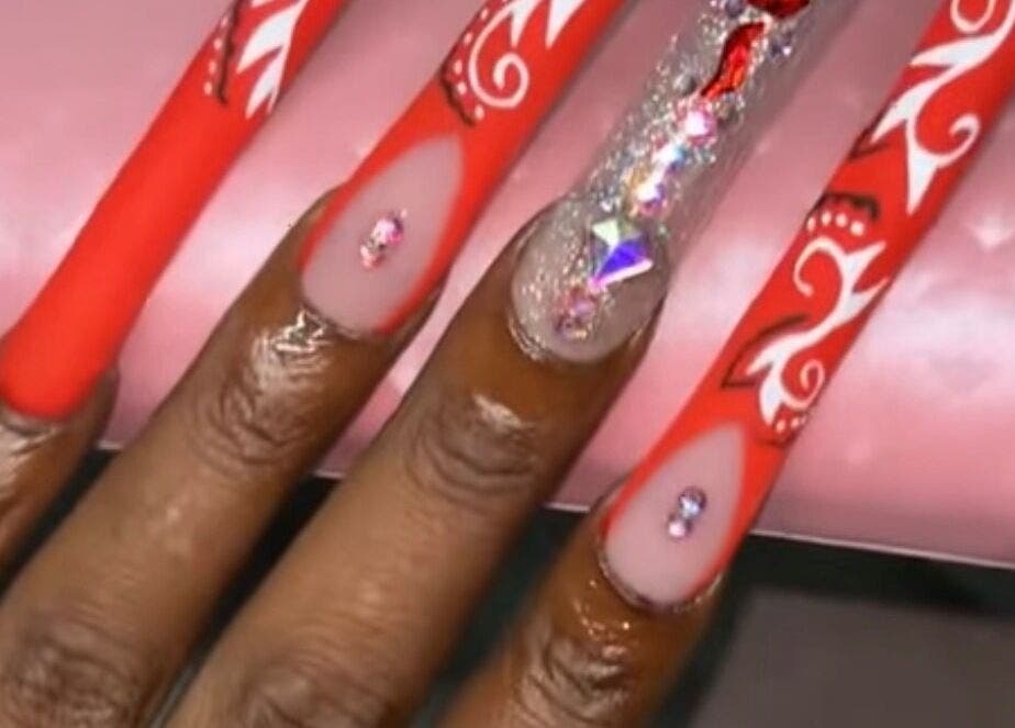 Elegant red and rhinestone nail design at Nailzbyari, Columbus, Ohio, US.
