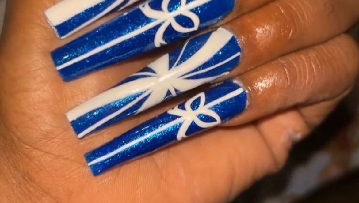 Intricate blue and white nail art at Nailzbyari, Columbus, Ohio, US.