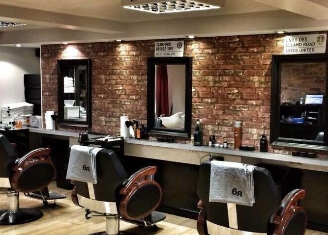 Modern barber chairs in rustic setting at Basement 68 Barbers, Leeds, England, GB.