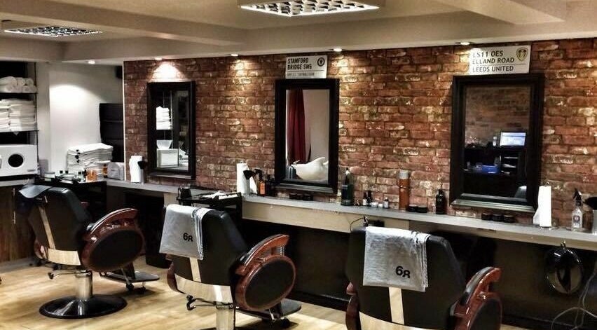 Modern barber chairs in rustic setting at Basement 68 Barbers, Leeds, England, GB.