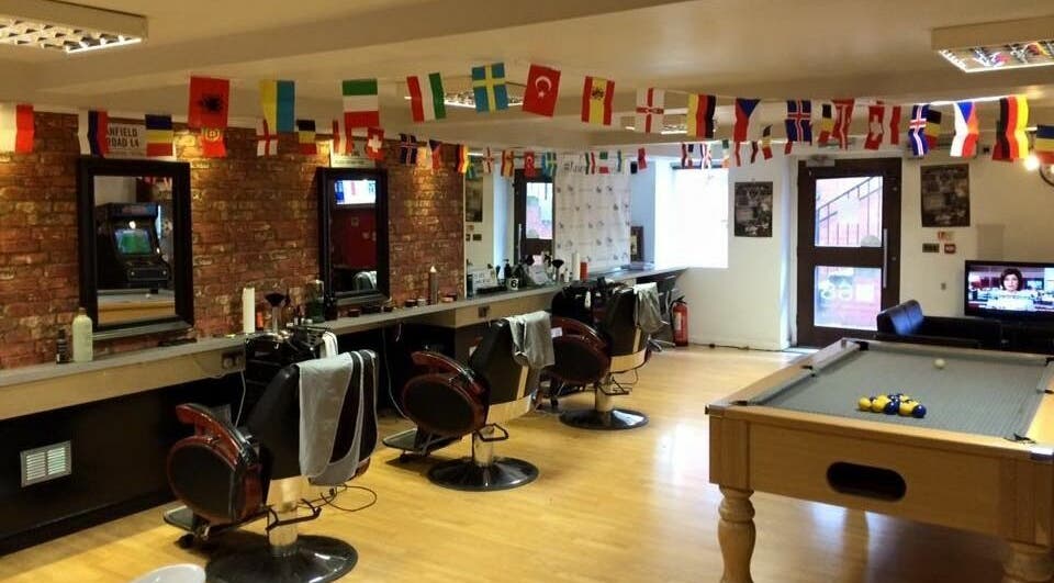 Spacious interior of Basement 68 Barbers, featuring barber chairs and pool table in Leeds, England, GB.