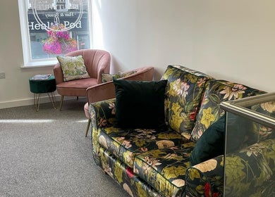 Stylish seating area at The Beauty Hut Pontyclun, showcasing floral decor and cozy ambiance in Pontyclun, Wales, GB.
