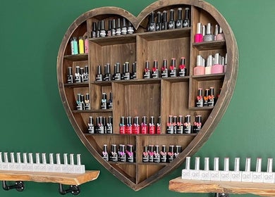 Heart-shaped shelf with nail polishes at The Beauty Hut Pontyclun, Pontyclun, Wales, GB.